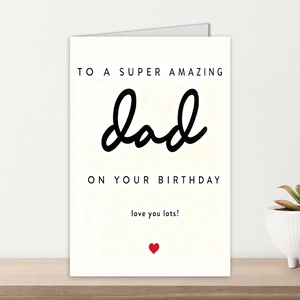 Detail of minimalist white birthday card for dad on wooden shelf with red heart icon