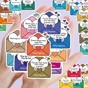Close-up of colorful cartoon envelope stickers with motivational quotes for journaling