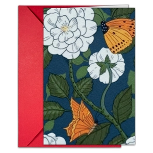 Close-up of vintage floral greeting card with red envelope showing linen paper texture