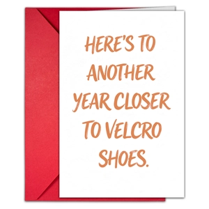 Detail of creative birthday card and red envelope with humorous text about getting older