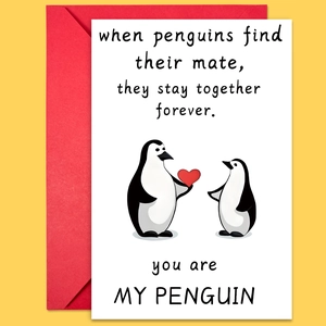 Close-up of penguin illustration greeting card with heart and matching red envelope