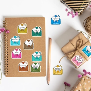 Detail shot of colorful envelope-style stickers with inspirational quotes on stationery