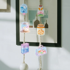 Detail of cute transparent PET stickers featuring cartoon dolphin and cat motifs on rope