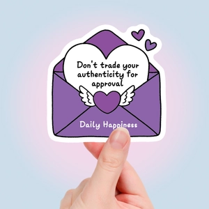 Close-up of purple envelope sticker with inspirational text and heart wings detail