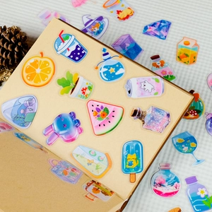 Close-up of cute cartoon PET stickers on a journal featuring cat and fruit designs