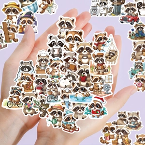 Close-up of diverse cute cartoon raccoon stickers held in hands for decorative use