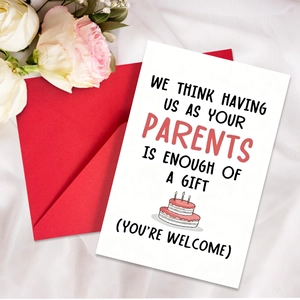 Close-up of humorous parents birthday card with a red envelope on white fabric