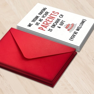 Creative birthday card and envelope set with humorous quote on light wood background