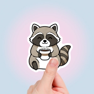 Cute raccoon sticker holding a coffee mug with flat illustration design and white border