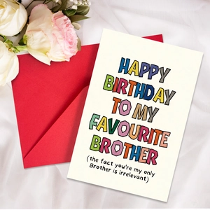 Folded birthday card with colorful text and red envelope on white wrinkled fabric