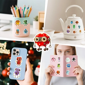 Detailed view of colorful cartoon robot stickers applied on laptop and stationery surfaces
