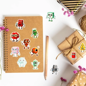 Close-up of colorful cartoon robot stickers on a notebook with stationery decor