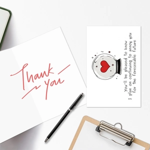 Close-up of white greeting card with Thank You text and artistic heart illustration