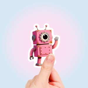 Close-up of hand holding a pink retro robot sticker with vintage rusty texture design
