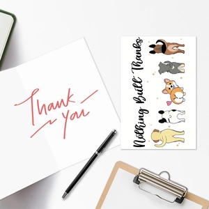 Detail of funny dog illustration thank you cards with envelope on a white desk