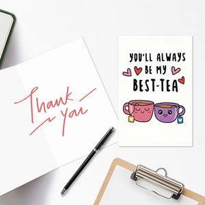 Flat lay of greeting cards with cartoon tea cups and handwritten Thank You text