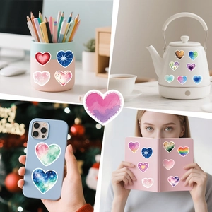 Creative watercolor heart stickers applied on phone cases and notebook surfaces