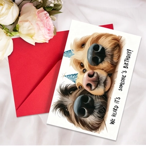 Close-up of birthday card with three dogs illustration and a vibrant red envelope