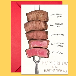 Detail of funny birthday card with steak illustrations and a vibrant red envelope