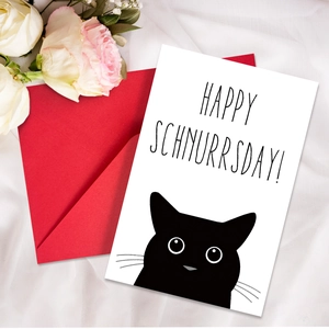 Detail of cute cat greeting card with red envelope on white fabric and roses