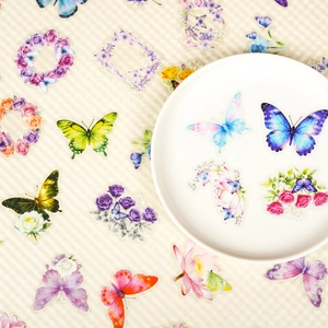 Dettaglio di adesivi in PET con farfalle e fiori su uno sfondo strutturato