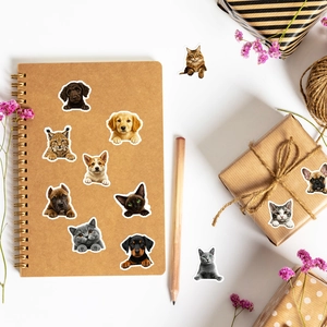 Realistic cat and dog stickers displayed on a craft notebook and gift box setup