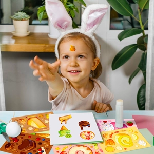Child with bunny ears playing with colorful cartoon dessert DIY puzzle stickers