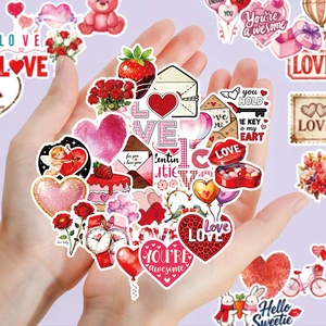 Close-up of Valentine stickers featuring red hearts and roses held in hand for gift decor