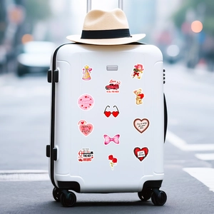 Detail of Valentine's stickers with heart and rose patterns on a white suitcase