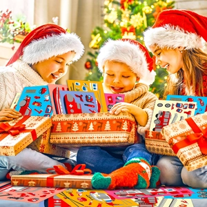 Three happy children opening a festive Christmas gift box filled with cartoon vehicle stickers