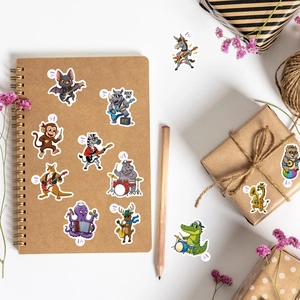Detailed stickers showing cartoon animals playing musical instruments on a notebook