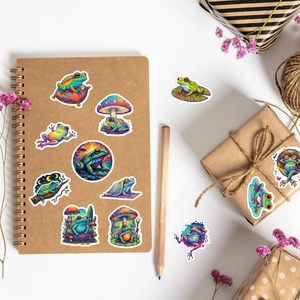 Artistic psychedelic frog stickers applied on a kraft notebook with rustic decor