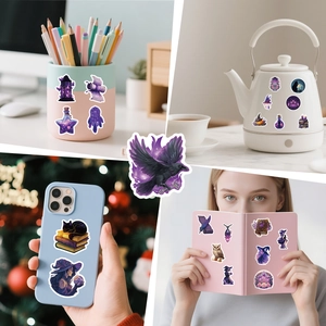 Detail showing magic theme stickers applied on phone case, laptop and water bottle