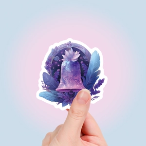 Close-up of mystical purple stickers with floral and feather patterns for journals