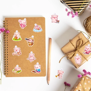 Detailed view of pink pig graffiti stickers on a notebook for DIY stationery decoration