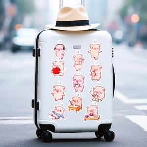 Close-up of pink pig cartoon stickers with easy-tear open tabs on a white suitcase