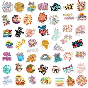 Flat lay of 50 colorful waterproof motivational text stickers for DIY planners and laptops