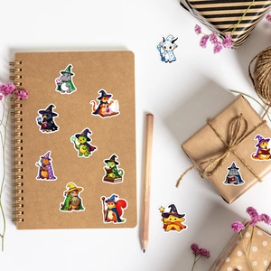 Flat lay of wizard animal stickers with notebooks, pencils, and purple dried flowers