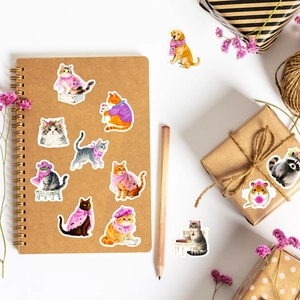 Close-up of cute pink cat and dog stickers on a kraft notebook with decorative accessories