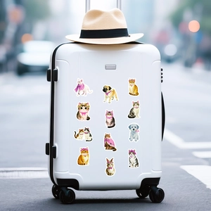 Detailed view of 12 cute pink cat and pet stickers applied on a white suitcase surface
