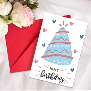 Close-up of neon birthday card with blue party hat and matching red envelope