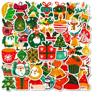 Flat lay of colorful Christmas stickers including Santa, trees, and bells on white background