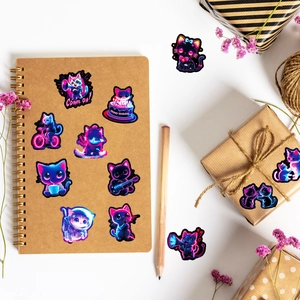 Detail view of colorful neon cat stickers on a notebook with vibrant pink and blue aesthetics