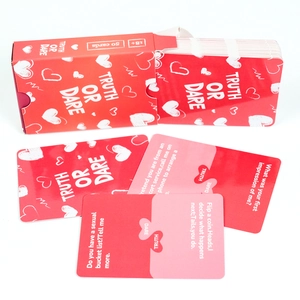 50 Truth or Dare game cards for couples in a deep red box with white heart patterns