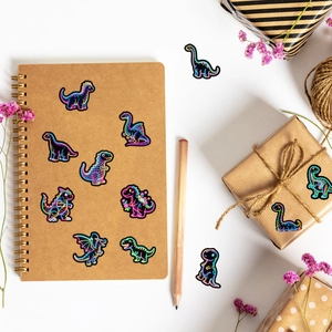 Neon dinosaur stickers on notebook and gift box with colorful glowing line art designs