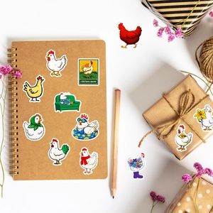 Macro detail of funny chicken stickers on notebook and gift box with creative art decor