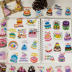 Detailed flat lay of birthday cake stickers with colorful patterns on a planner page