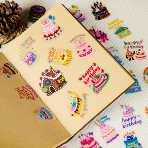 Close-up of colorful cartoon cake stickers on a kraft notebook for birthday decoration