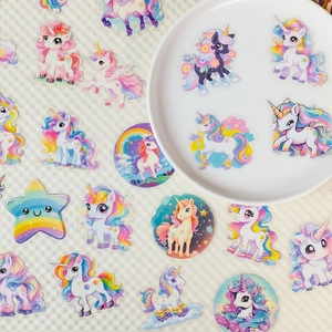 Detailed view of cute unicorn PET stickers with rainbow and stars on a white plate