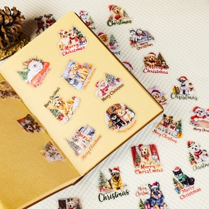 Macro shot of cute Christmas dog stickers with festive greetings on a notebook